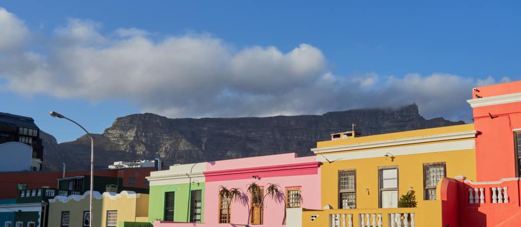 Brightly painted houses in Bo-Kaap, Cape Town, under Table Mountain.